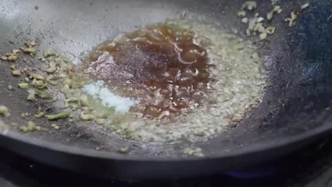 Chef preparing savory barbecue steak sauce in a seasoned wok, close-up Stock Footage 338211825