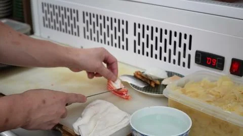 Chef preparing seafood ingredients on a cutting board in a restaurant kitchen Stock Photos