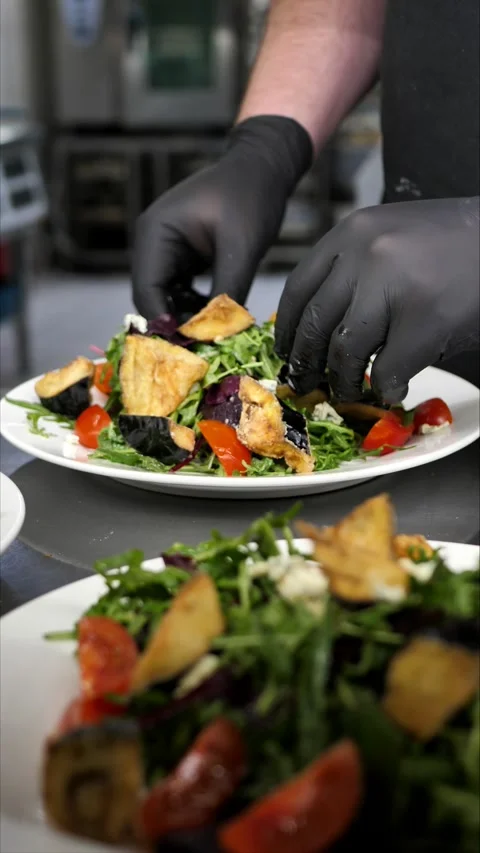 Chef preparing to serve fresh vegetable salad with grilled vegetables. Stock Footage 306845894