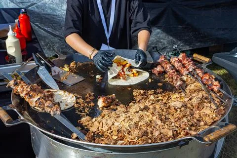Chef Preparing Shawarma Wrap And Shish Kebab On Griddle Stock Photos