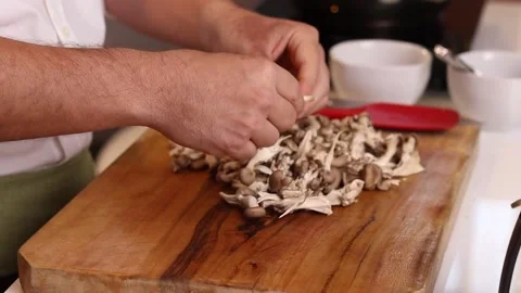 Chef preparing shitake mushrooms on a table Stock Footage 153766014
