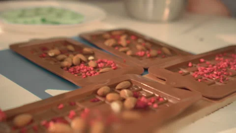 Chef preparing silicon foms for chocolate with almond nuts and dried berries Stock Footage 202189654