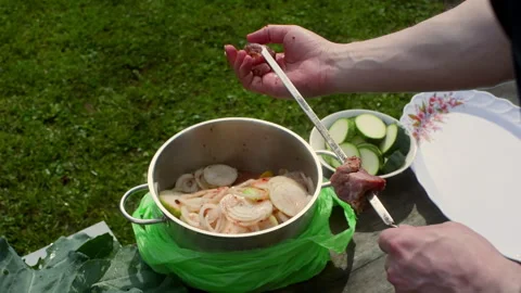 Chef preparing a skewer with pieces of meat Stock Footage 296692040