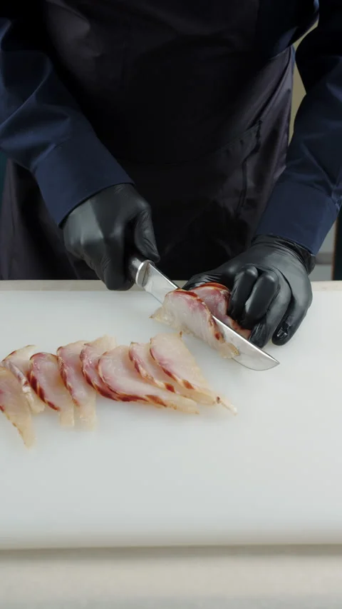 Chef preparing slices of smoked fish fillet Stock Footage 308033689