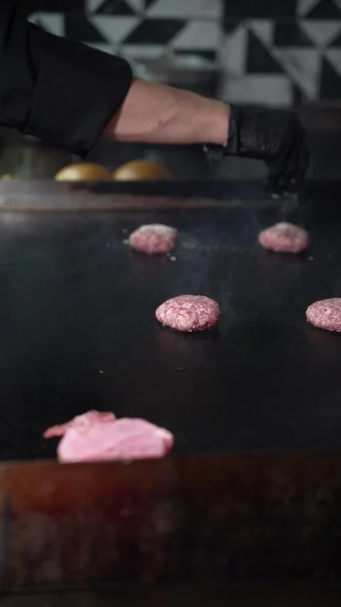 The chef is preparing smash burgers. Stock Footage 294956061