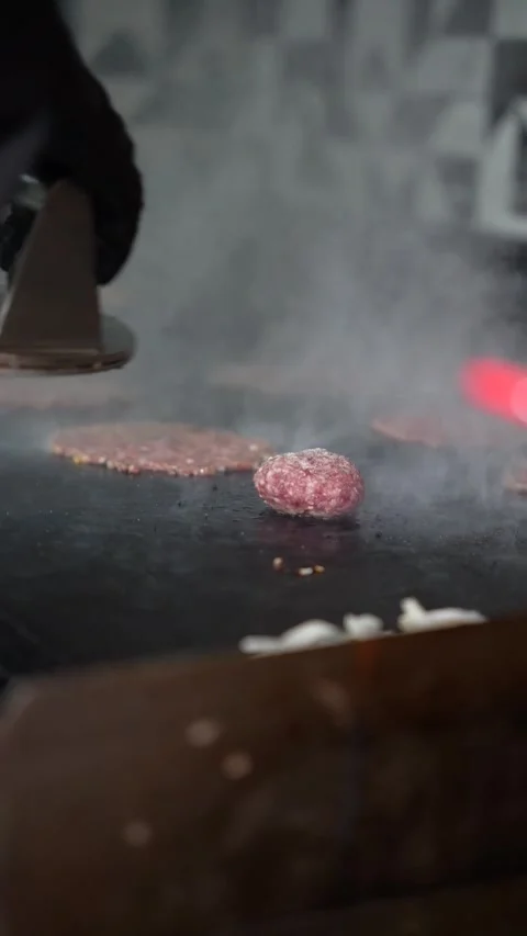 The chef is preparing smash burgers. Stock Footage 294956064