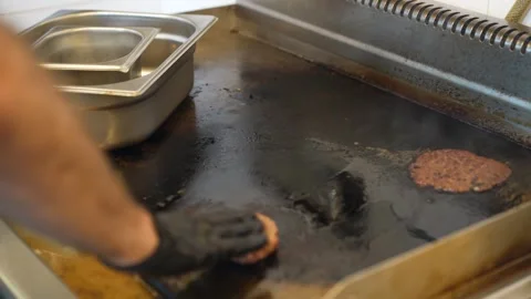 The chef is preparing smash hamburgers Stock Footage 294955651