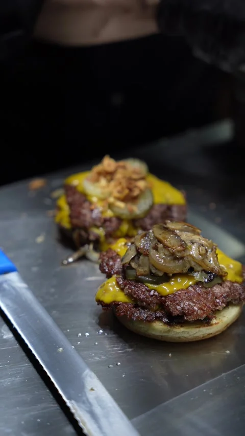 The chef is preparing smash hamburgers Stock Footage 294956013