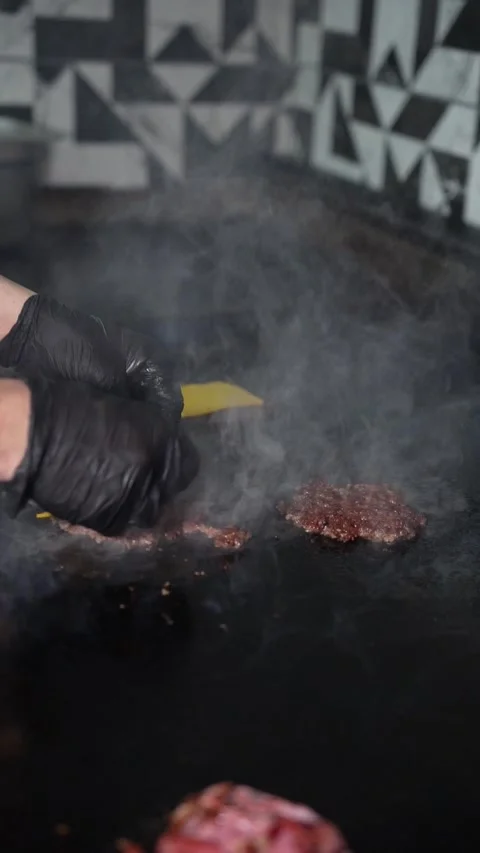 The chef is preparing smash hamburgers Stock Footage 294956032