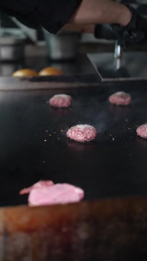 The chef is preparing smash hamburgers Stock Footage 294956069