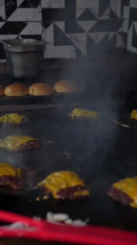 The chef is preparing smash hamburgers Stock Footage 294956096