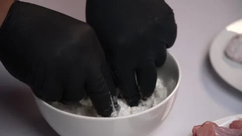 The chef is preparing some chicken legs to fry Close up. Видео 144170806