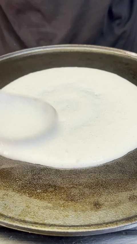 A chef preparing south Indian dosa on hot plate. Stock Footage 287810657