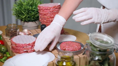 Chef preparing special seasoned raw meat burgers on trendy kitchen surface Stock Footage 223739384