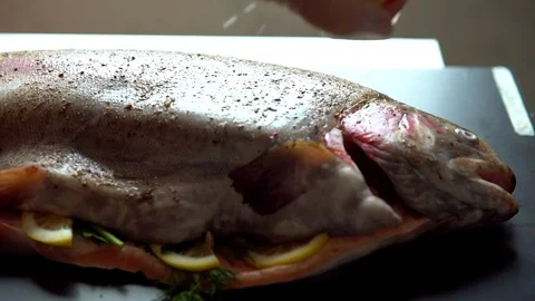 Chef preparing a stuffed raw fish for baking Video stock 105134885