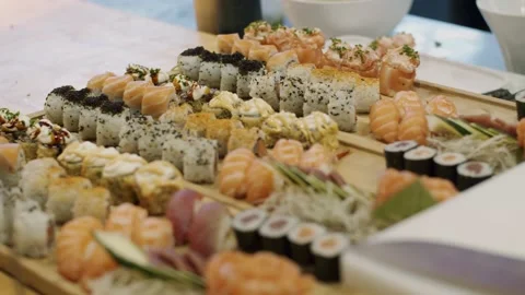 Chef Preparing Sushi in a Restaurant, using ingriedients, fish and knife cuts Stock Footage 139313754