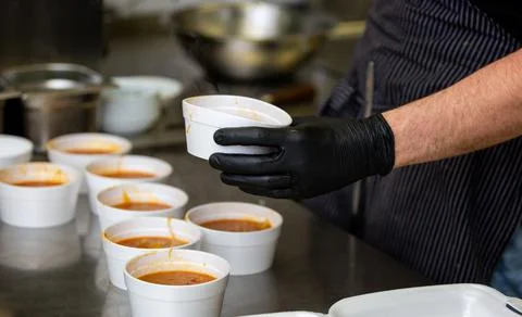 Chef preparing takeaway dish in restaurant or pub, food delivery concept, home Stock Photos