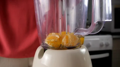 Chef preparing tangerine juice adding honey syrup in blender on kitchen. Stock Footage 317232783