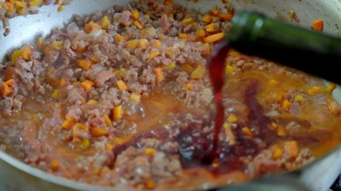 A chef preparing tomato sauce with meat, adding red wine to the sauce italian Stock Footage 309056759