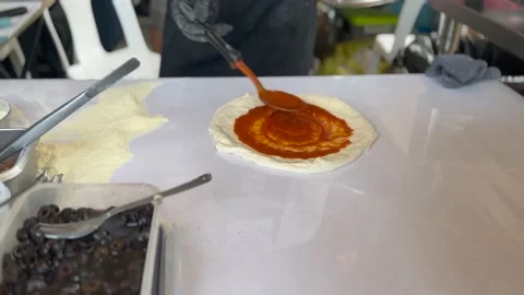 Chef preparing tomato sauce on pizza dough. Stock Footage 232927717