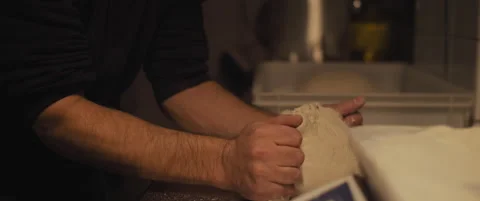Chef preparing traditional pizza dough with his hands, slowly kneading dough. Stock Footage 146919055