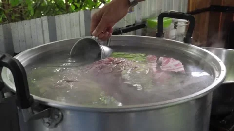 Chef Preparing Traditional Thai Beef Broth in a Large Stainless Steel Stock Pot Stockbeeldmateriaal 338211106