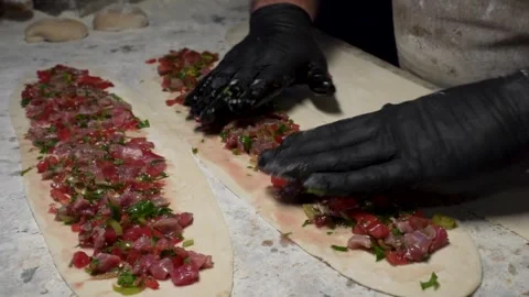 Chef Preparing Traditional Turkish Pide Filling with Black Gloves Stock Footage 323182776