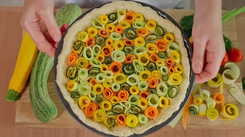 The chef is preparing a Tuscan pie with colorful zucchini and carrots Stock Footage 264141635
