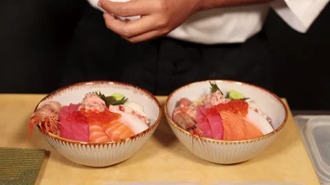 Chef Preparing Two Japanese Sashimi Donburi Seafood Bowls with Raw Fish Video stock 341299324