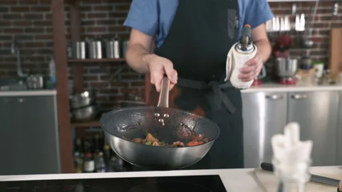 Chef Preparing Vegetables In Flambe Style. Cooking Delicious Food In Kitchen. 動画素材 142808131