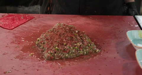 Chef preparing vegetarian salad dip sauce traditional Turkish ezme, add spices Stock Footage 295955930