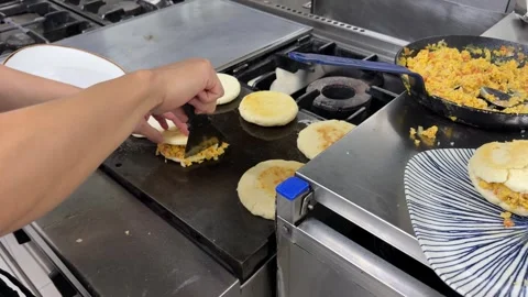 Chef preparing venezuelan arepas with scrambled eggs 스톡 동영상 344100189