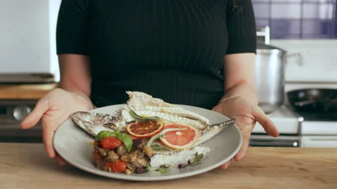 Chef prepping and serving delicious fish dish. Medium close on a RED camera. Stock Footage 199460806