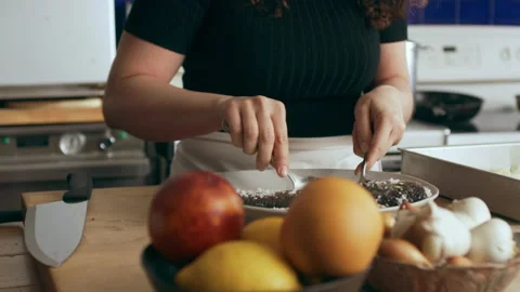 Chef prepping fish in a large well appointed kitchen with an array of a equipmen Stock Footage 199462670
