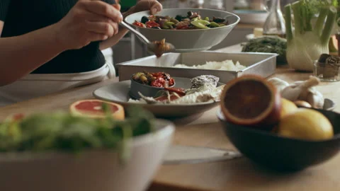 Chef prepping, plating and garnishing fish in a large well appointed kitchen wit Stock Footage 199460690