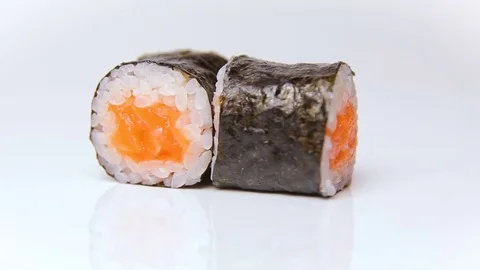 Chef presentation of restaurant sushi rolls rotating on white Stock Footage 80566197