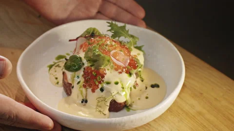 The chef presents a freshly cooked benedict brioche sandwich with salmon  Video stock 151295487