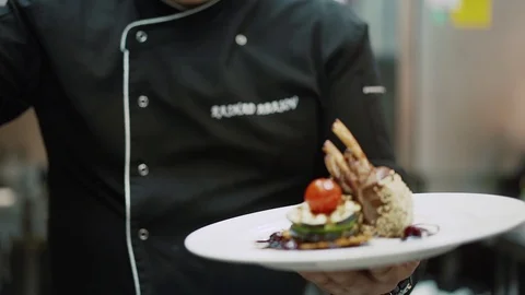 Chef presents his dish chicken legs with tomato and sesame seeds Stock Footage 126035495
