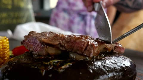 The Chef presents a new dish - slicing juicy delicious grilled steak meat Stock Footage 52194497