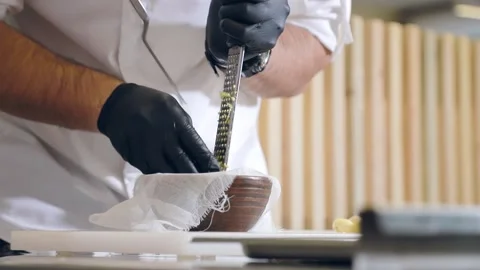 The chef processes the celery root into small pieces. Rub the celery root on a Stock Footage 147317752