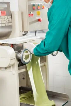 Chef Processing Spaghetti Pasta Sheet In Machinery Stock Photos