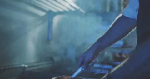 Chef in professional kitchen cooking a meal at the stove Stock Footage 203559690