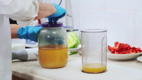 Chef in professional kitchen make sweet sause Stock Footage 211346421