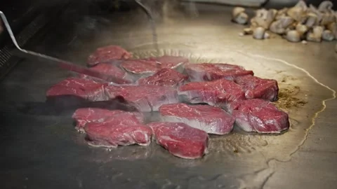 The chef in the professional kitchen of the restaurant roasts juicy meat in a Video stock 278401721