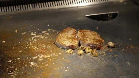 The chef in the professional kitchen of the restaurant roasts juicy meat, steak Video stock 278511048