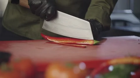 The chef professionally cuts red hot pepper into strips. Stock Footage 230705209