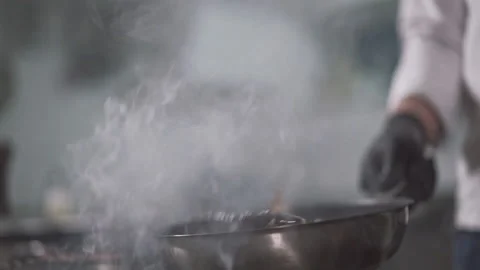 The chef professionally fry the fish in a pan until fully cooked Stock Footage 150418964