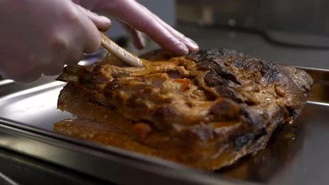 Chef pulls bones out of piece of baked brisket Video stock 151554964