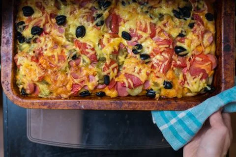 Chef pulls fresh pizza out of the oven Stock Photos