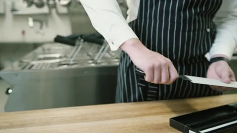 The chef pulls out a sharp knife Stockbeeldmateriaal 148499555